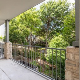 State-of-the-art amenities a spacious balcony overlooking many trees